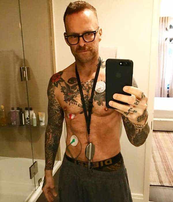 Dashing Bob Harper taking shirtless selfie in front of mirror showing his body full of tattoo