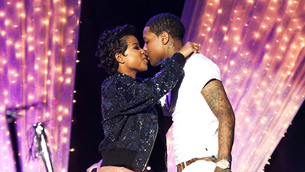 Lil Durk and Dej Loaf kissing while performing on stage