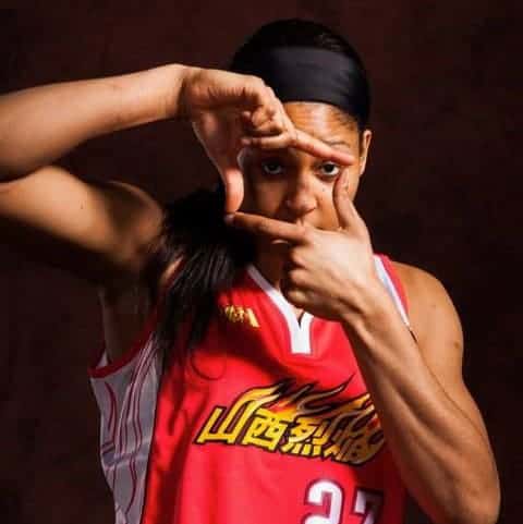 Maya Moore posing for picture on her club jersi