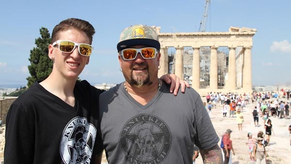 Guy and Hunter Fieri in Athens, Greece, in front of the Acropolis, as seen in Guy's European Vacation Episode 1 from Food Network.